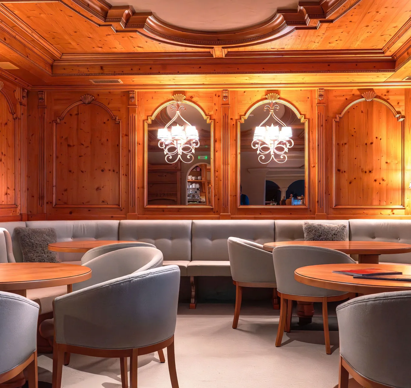Sala interna con pareti rivestite in legno, divani e tavolini eleganti