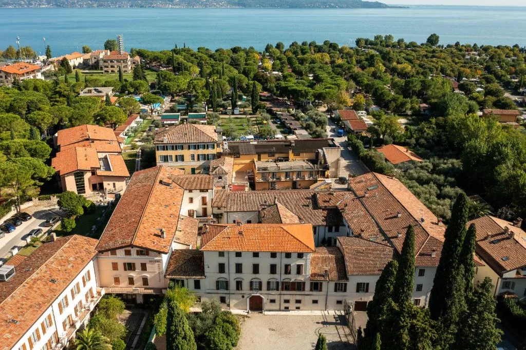 Veduta aerea del complesso alberghiero immerso nel verde con il lago sullo sfondo