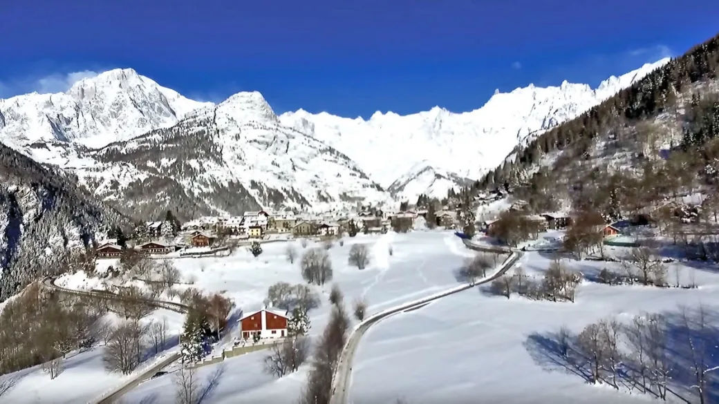Veduta panoramica di un villaggio alpino innevato circondato da alte montagne