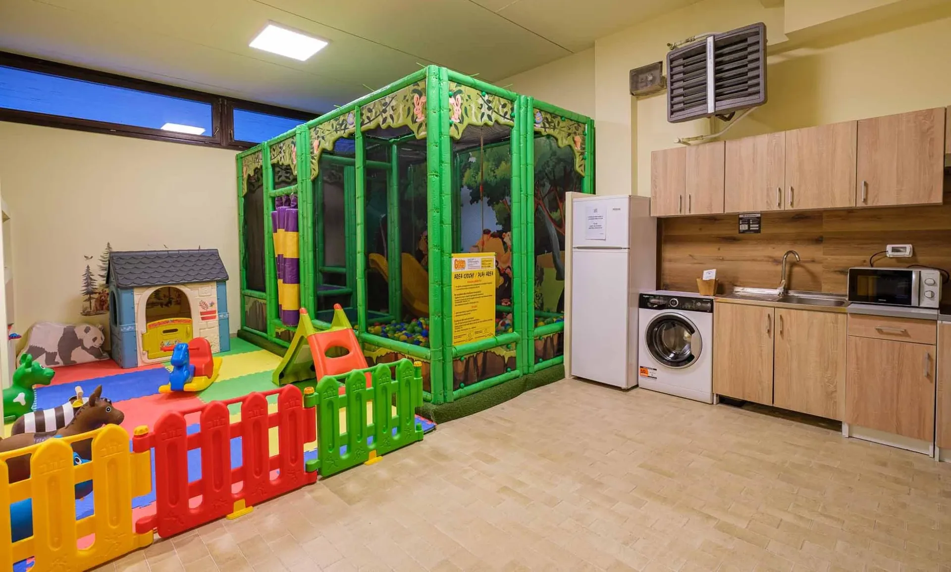 Area giochi per bambini con struttura morbida e angolo cucina