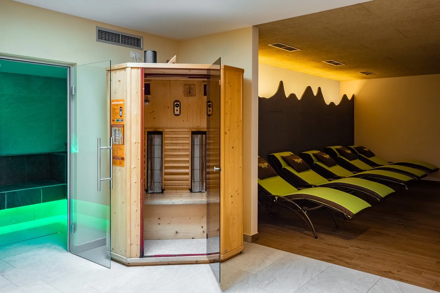Area wellness con sauna a infrarossi, bagno turco illuminato e lettini relax